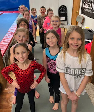 A coach with a small gymnastics class at Apex Gymnastics